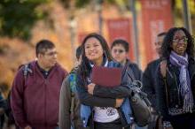 Female student walking with books on campus